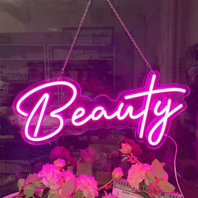 Insegna Neon Led personalizzata rappresentante la scritta "beauty" appesa con catena in acciaio